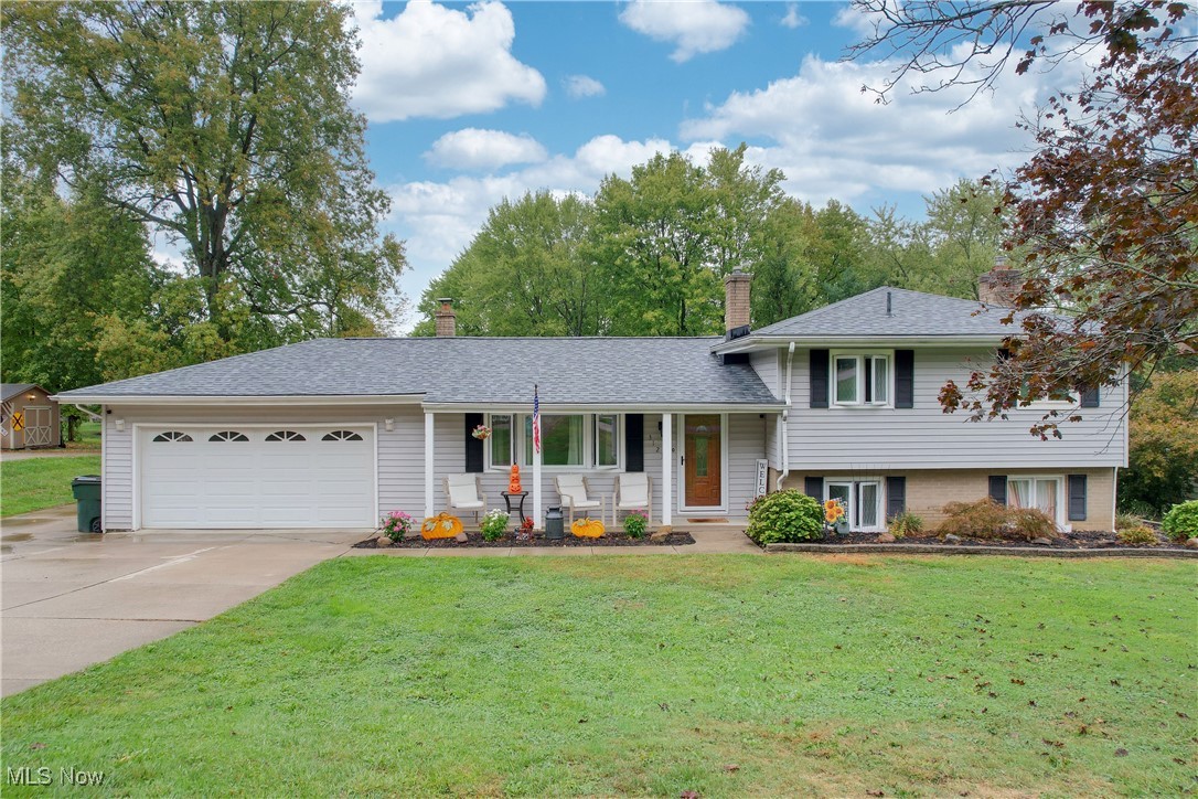 3123 Clearview Road Ravenna, OH 44266 - Photo 1 of 44 Tri-level home with covered porch, a front yard, concrete driveway, and a garage