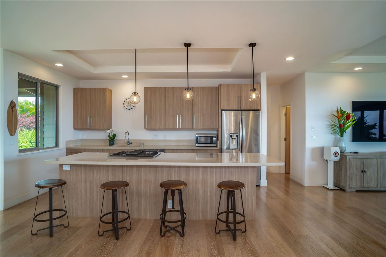 1855 Kauhikoa Road, Unit A Haiku, HI 96708 - Photo 1 of 30 a kitchen with cabinets and wooden floor
