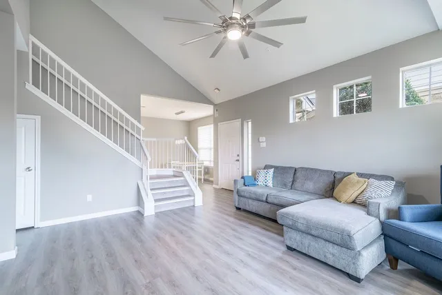 a living room with furniture and a wooden floor