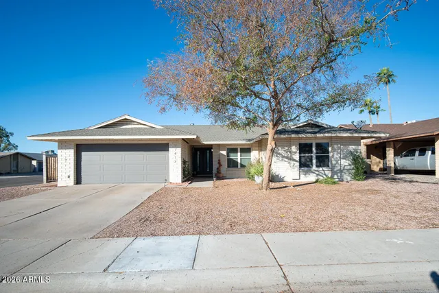 a front view of a house with a yard and a garage