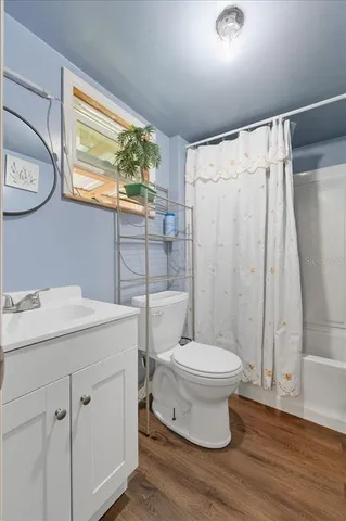 a bedroom with a bed dresser and a window