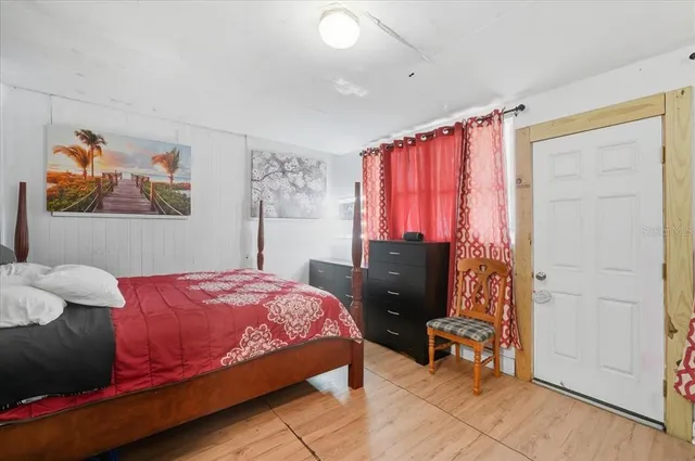 a bedroom with a bed and a mirror