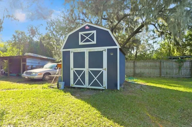a view of backyard with swimming pool and outdoor seating