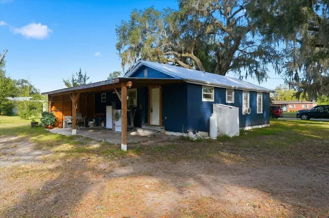 a view of a house with a yard and tree s
