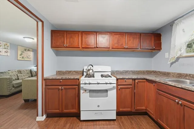 a kitchen with a stove top oven sink and cabinets