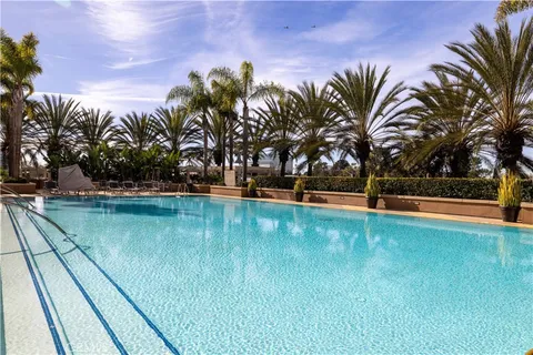 a view of swimming pool with outdoor seating and yard in back