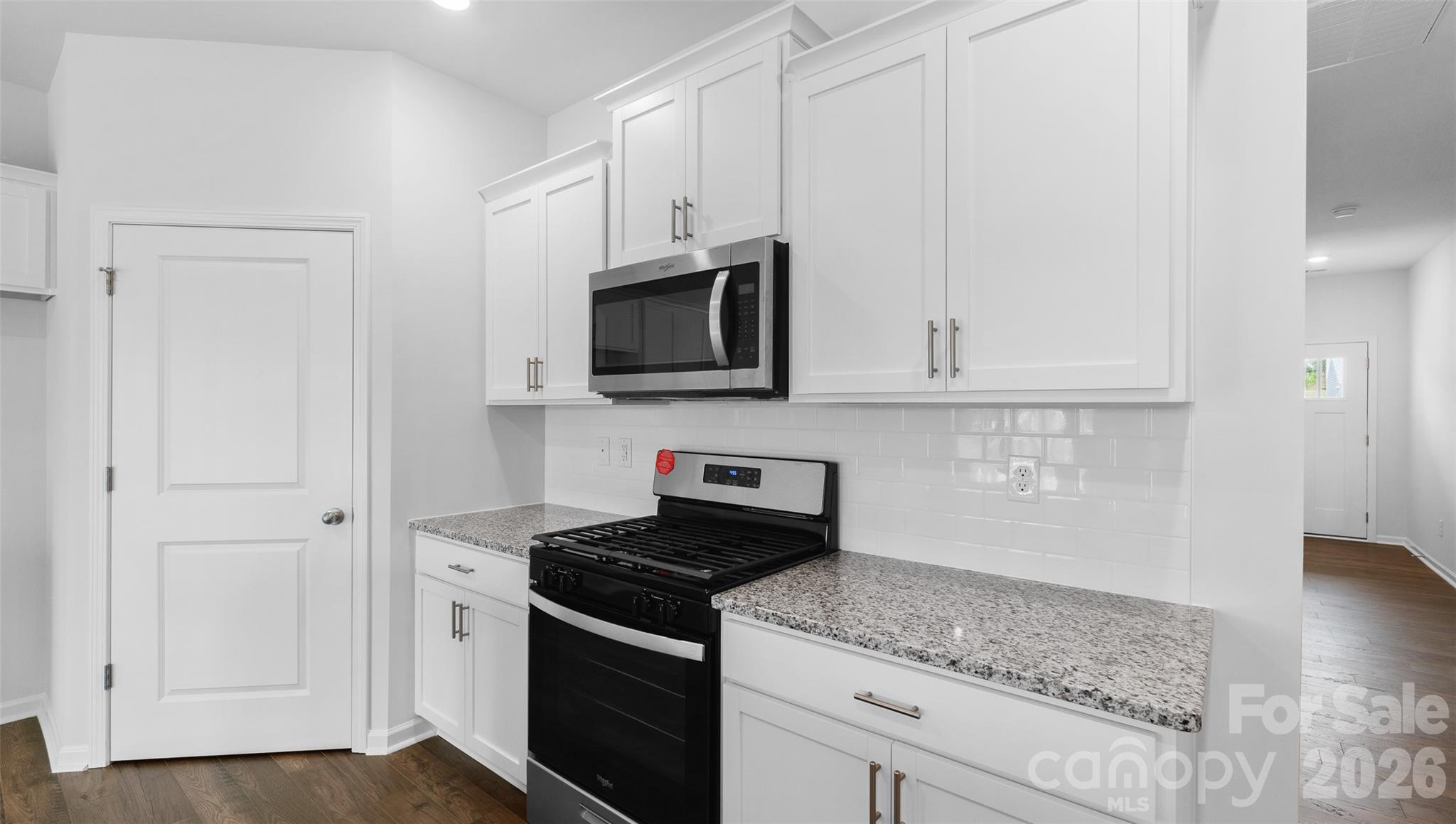 107 Bovine Br Road Fletcher, NC 28732 - Photo 3 of 20 a kitchen with stainless steel appliances granite countertop white cabinets and a stove top oven