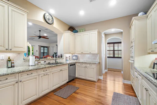 a large kitchen with a sink and cabinets