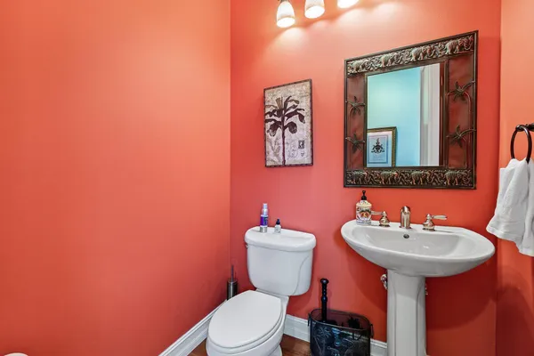 a bathroom with a toilet sink and mirror