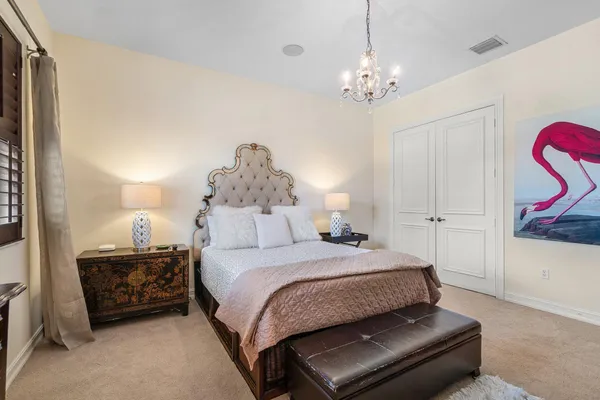 a bedroom with a bed and a chandelier