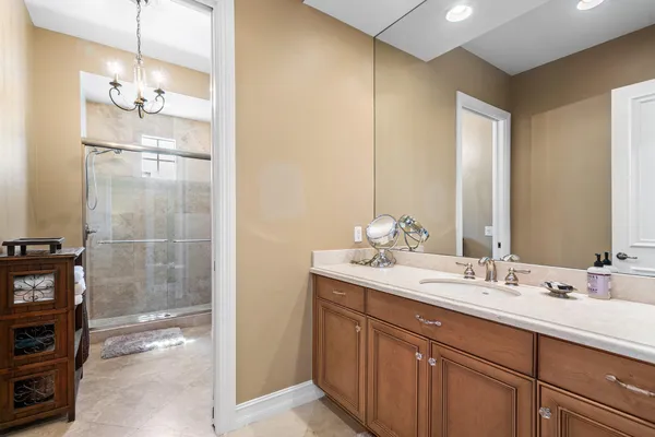 a bathroom with a double vanity sink mirror and shower