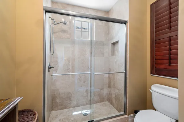 a bathroom with a shower and toilet