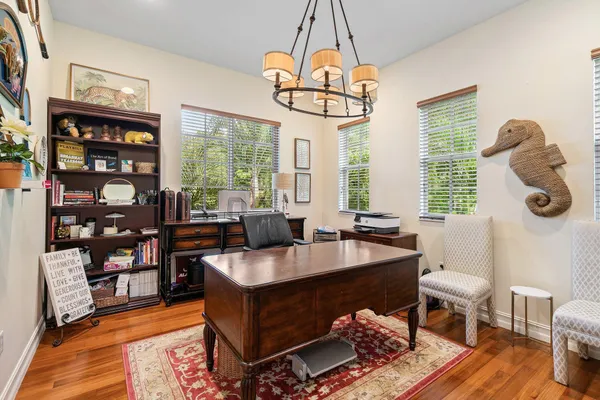 a kitchen with stainless steel appliances granite countertop a sink a stove and a wooden floors