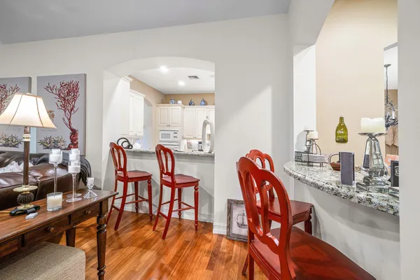 a dining room with furniture and wooden floor