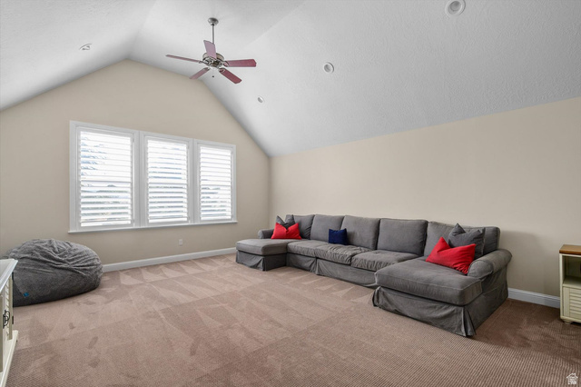 1456 Firelight Way Sandy, UT 84092 - Photo 9 of 22 Carpeted room featuring a vaulted ceiling with a ceiling fan