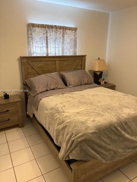 1911 Southwest 23rd Street Miami, FL 33145 - Photo 13 of 25 a bedroom with a bed and window