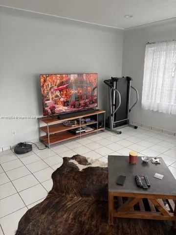 a room with furniture and a flat screen tv