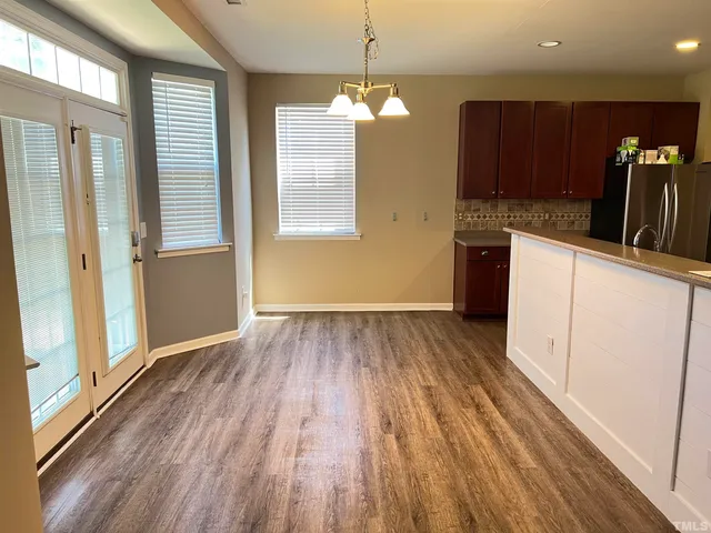 a kitchen with wooden cabinets and stainless steel appliances
