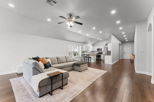 a living room with furniture and kitchen view