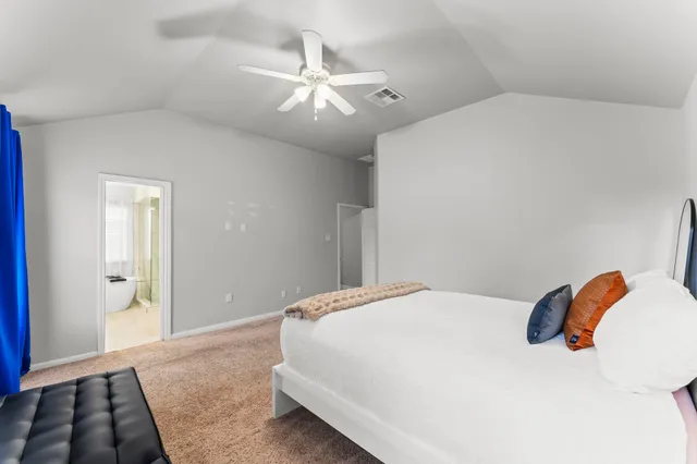 a bedroom with a bed and a lamp