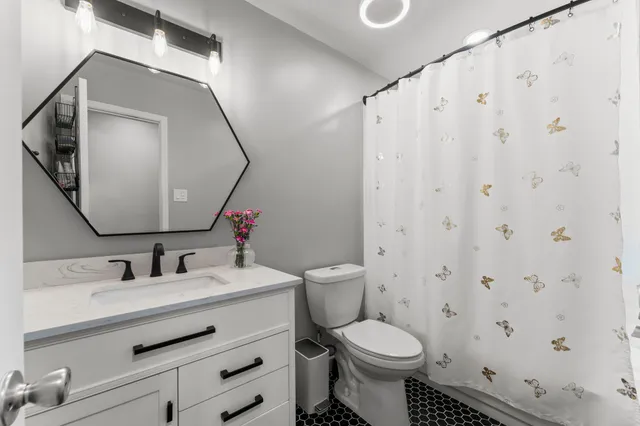 a bathroom with a sink toilet and mirror