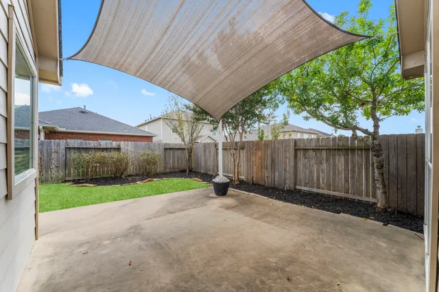 a view of a backyard with wooden fence
