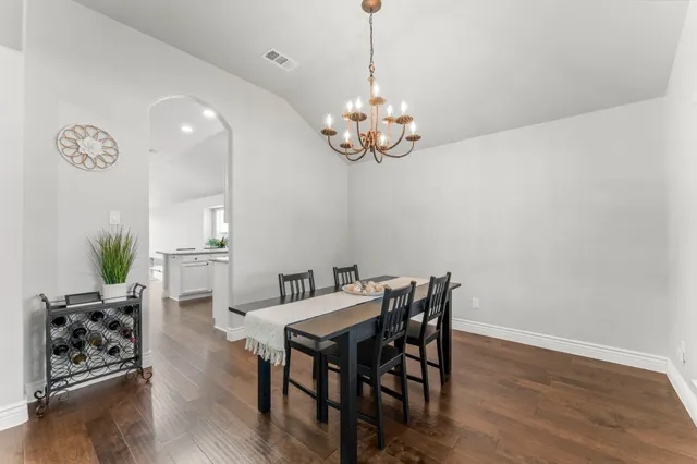 a view of a dining room with furniture wooden floor and chandelier