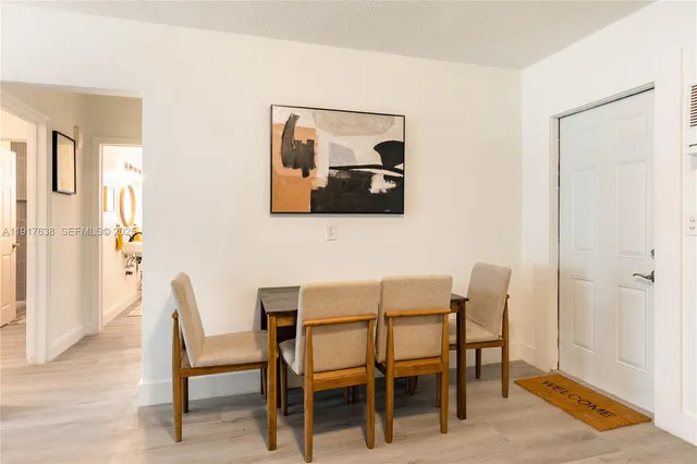 a dining room with furniture and window