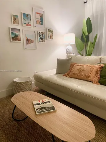 a living room with furniture and painting on the wall