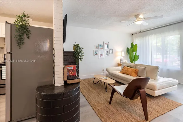 a living room with furniture and a potted plant