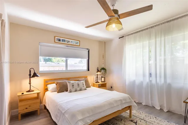 a bedroom with a bed and a large window