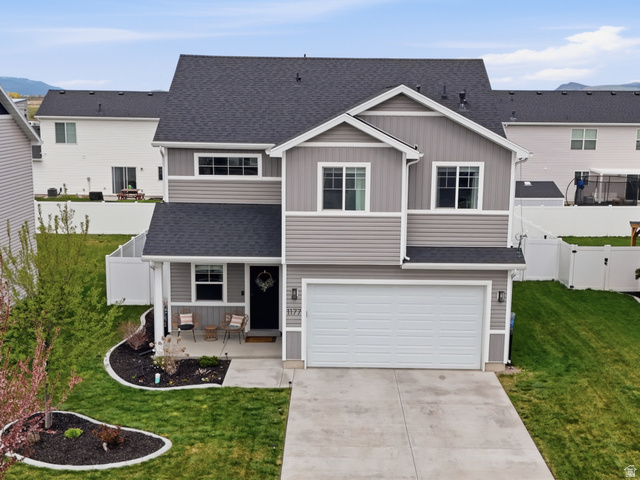 1177 West 240 South Logan, UT 84321 - Photo 1 of 1 Craftsman-style home with a residential view, board and batten siding, an attached garage, and covered porch