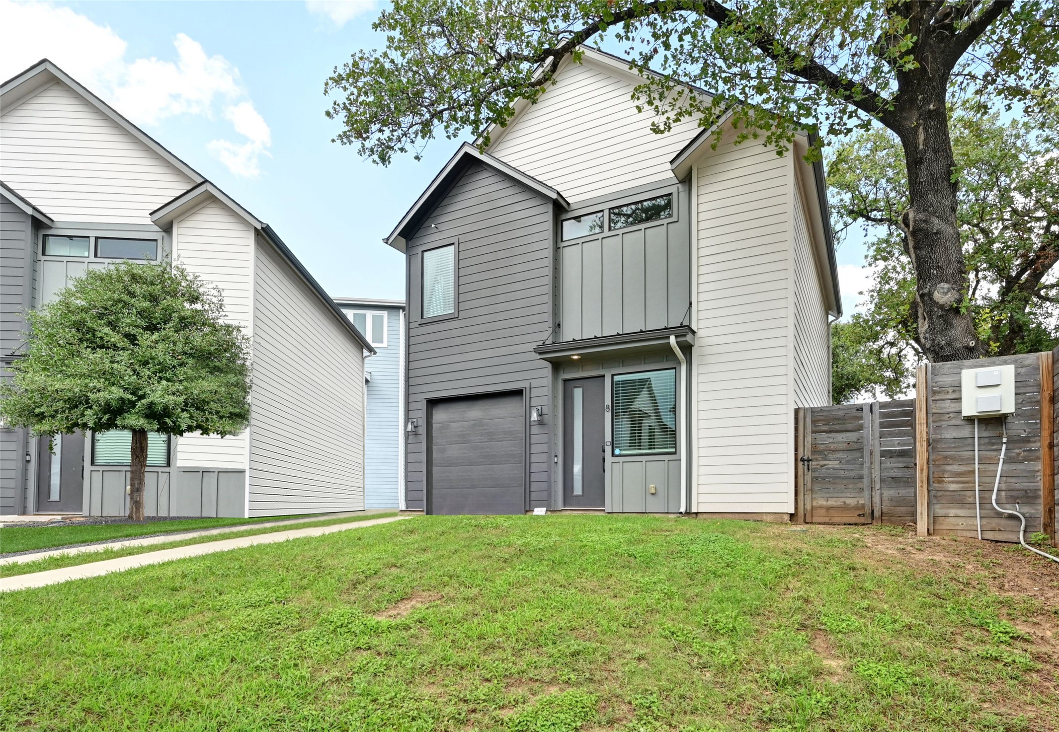 View of front of property with an attached garage and board and batten siding