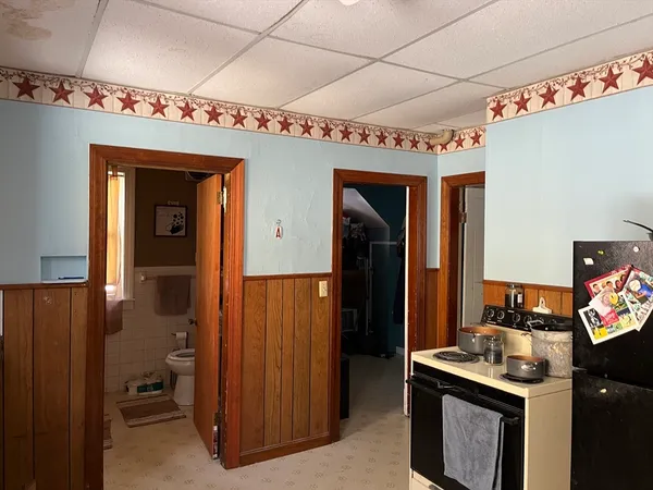 a kitchen with stainless steel appliances granite countertop a refrigerator and a stove