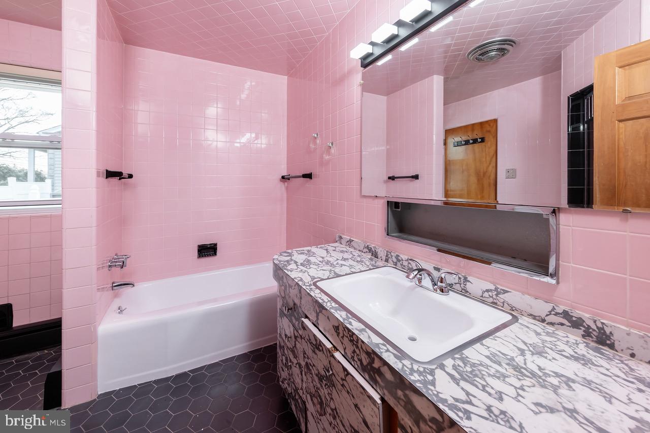 901 Pennsylvania Avenue Cherry Hill, NJ 08002 - Photo 16 of 20 a bathroom with a tub sink and mirror