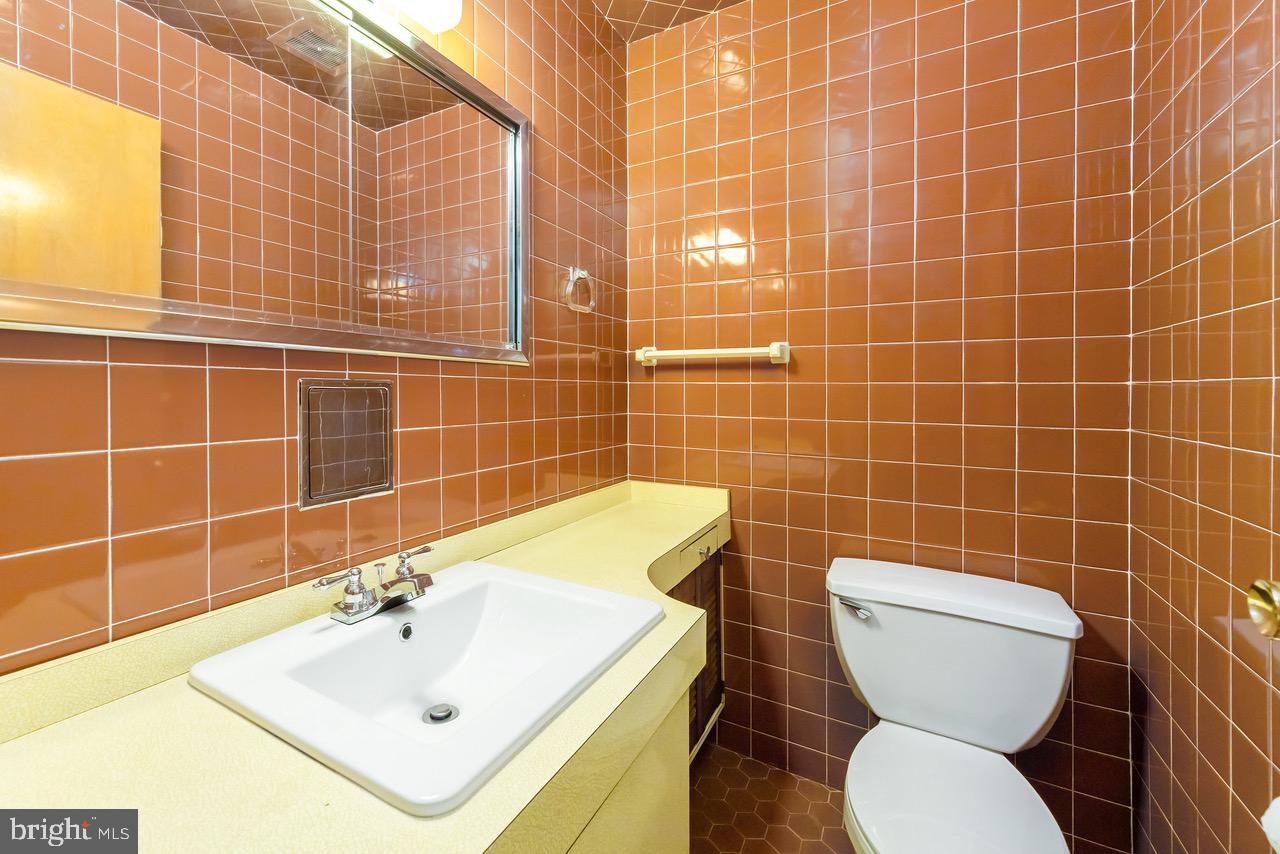 901 Pennsylvania Avenue Cherry Hill, NJ 08002 - Photo 18 of 20 a bathroom with a sink a toilet and mirror