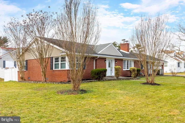 a view of a house with pool and chairs