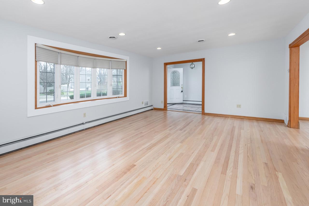 901 Pennsylvania Avenue Cherry Hill, NJ 08002 - Photo 6 of 20 a view of an empty room with wooden floor and a window