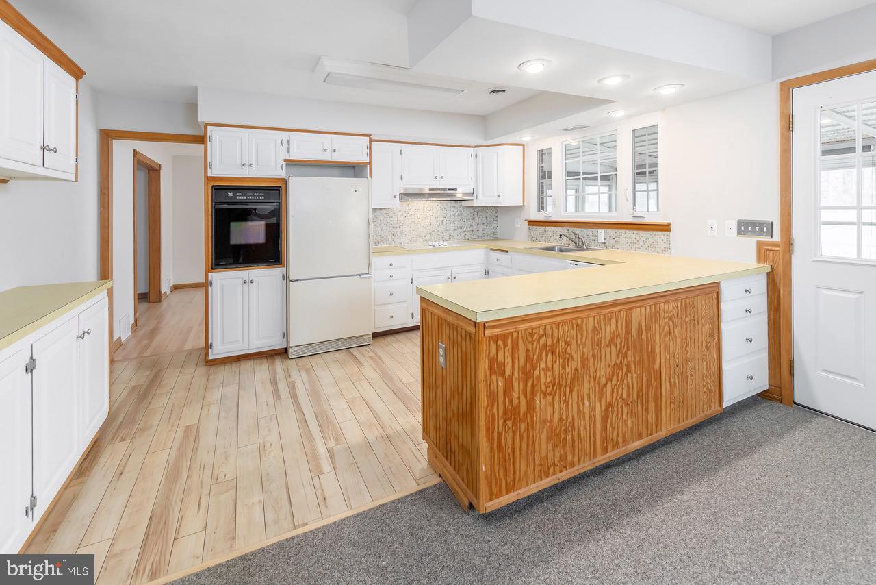 901 Pennsylvania Avenue Cherry Hill, NJ 08002 - Photo 10 of 20 a kitchen with stainless steel appliances granite countertop a stove a refrigerator a sink and white cabinets with wooden floor