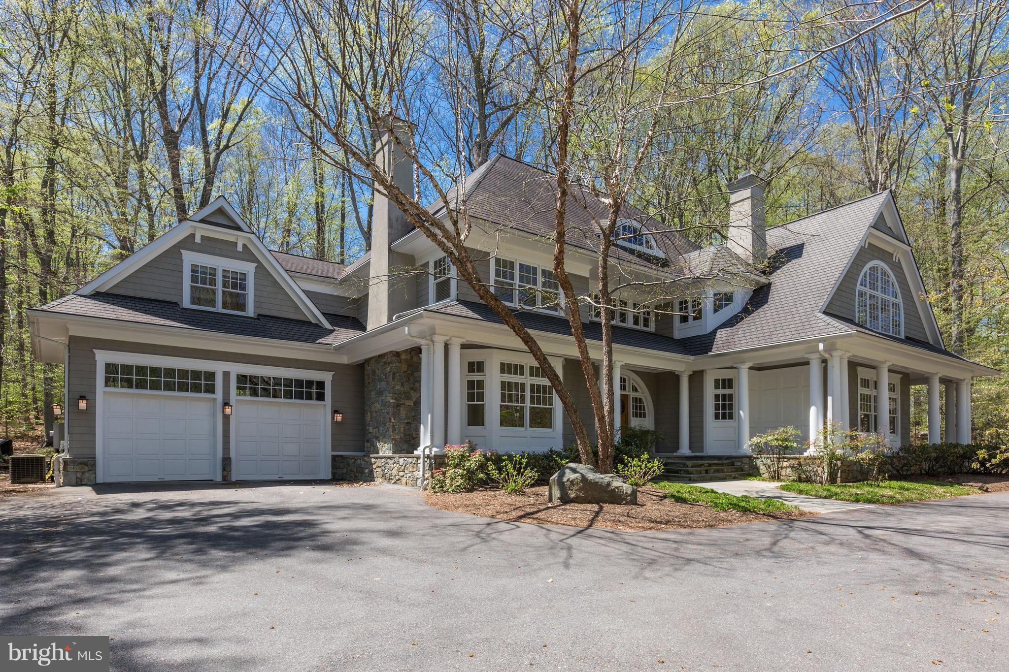 8610 Fernwood Road Bethesda, MD 20817 - Photo 1 of 30 a front view of a house with a yard and garage
