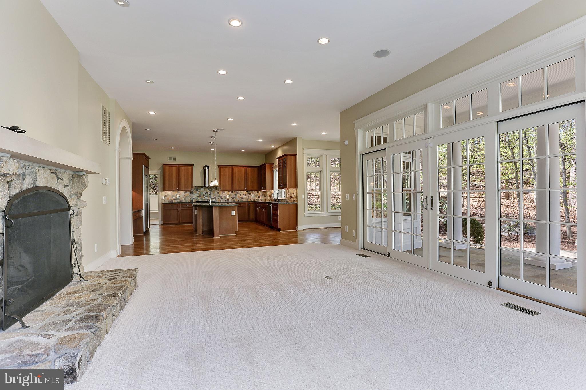 8610 Fernwood Road Bethesda, MD 20817 - Photo 12 of 30 a view of an empty room with kitchen and fireplace