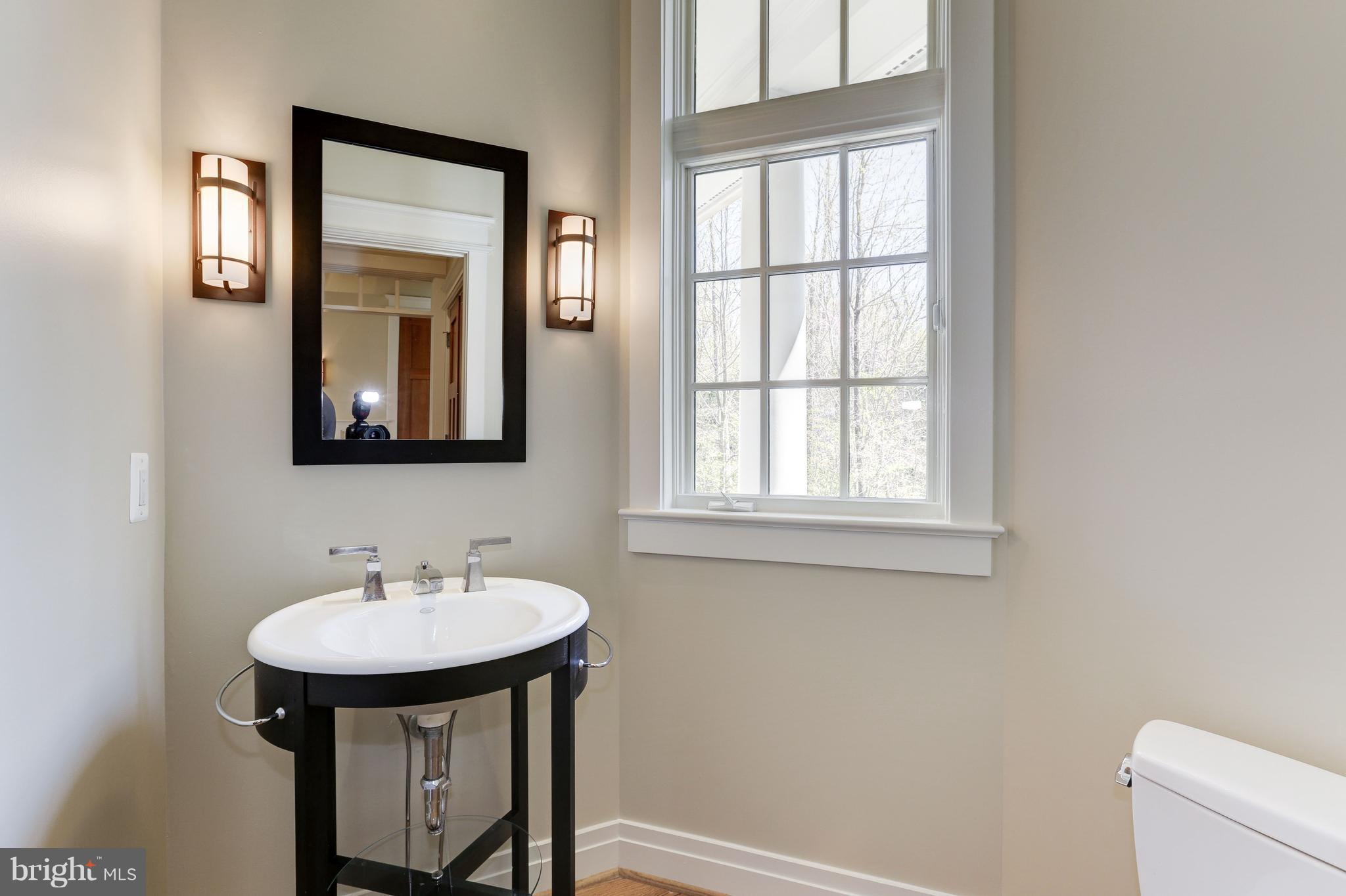 8610 Fernwood Road Bethesda, MD 20817 - Photo 13 of 30 a bathroom with a sink and a mirror