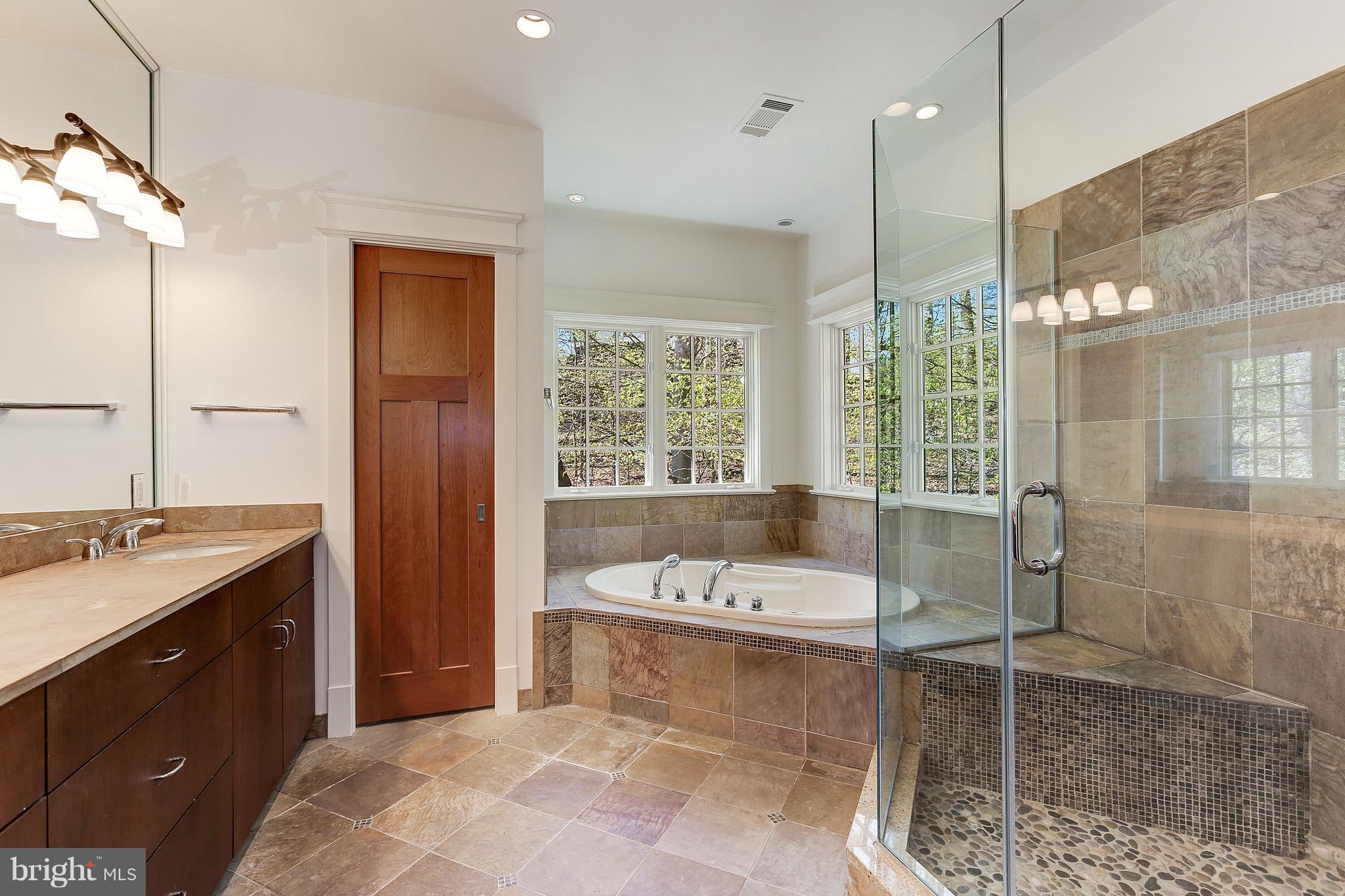 8610 Fernwood Road Bethesda, MD 20817 - Photo 17 of 30 a bathroom with a tub sink and mirror