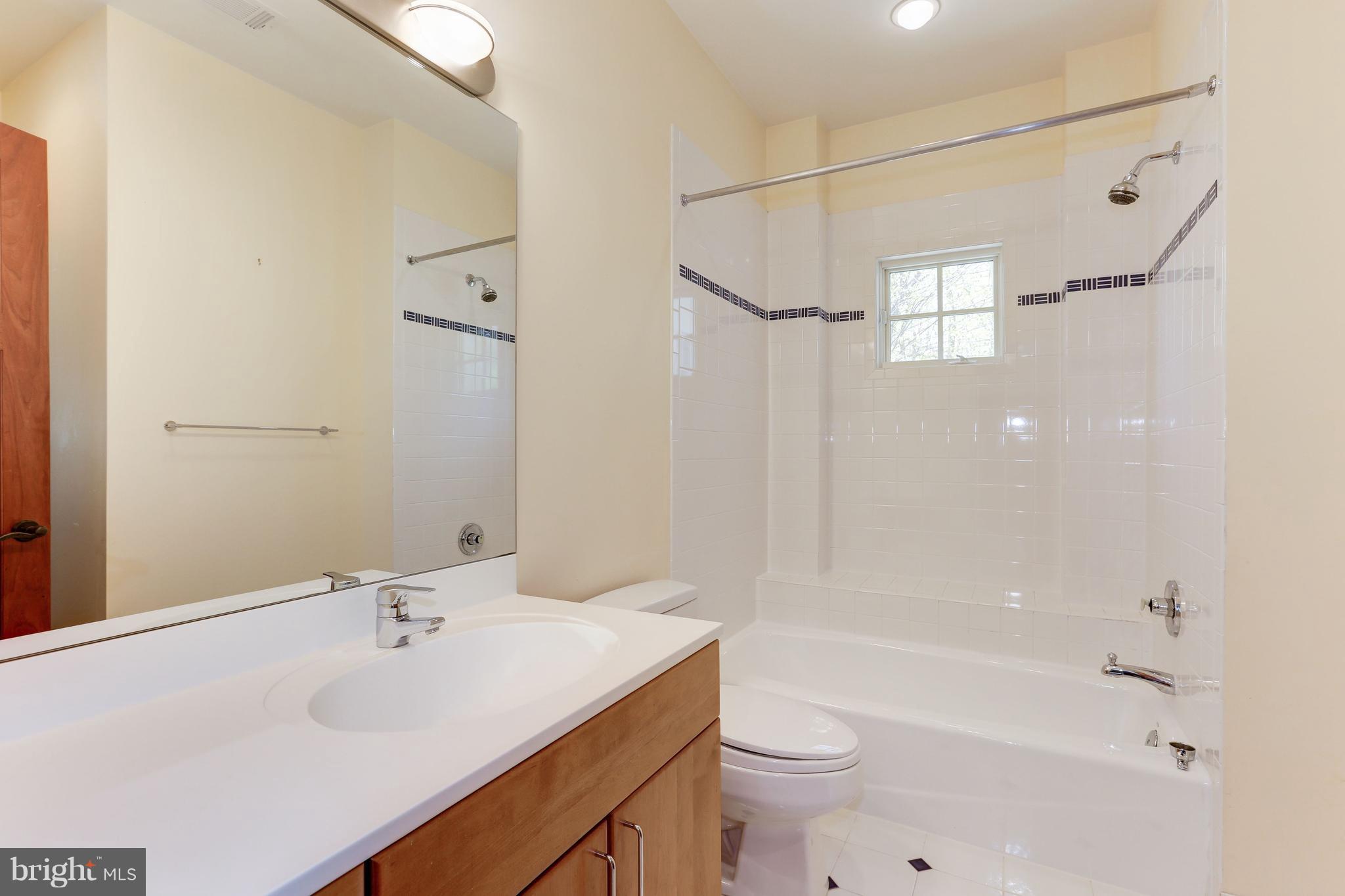 8610 Fernwood Road Bethesda, MD 20817 - Photo 19 of 30 a bathroom with a sink toilet tub and shower