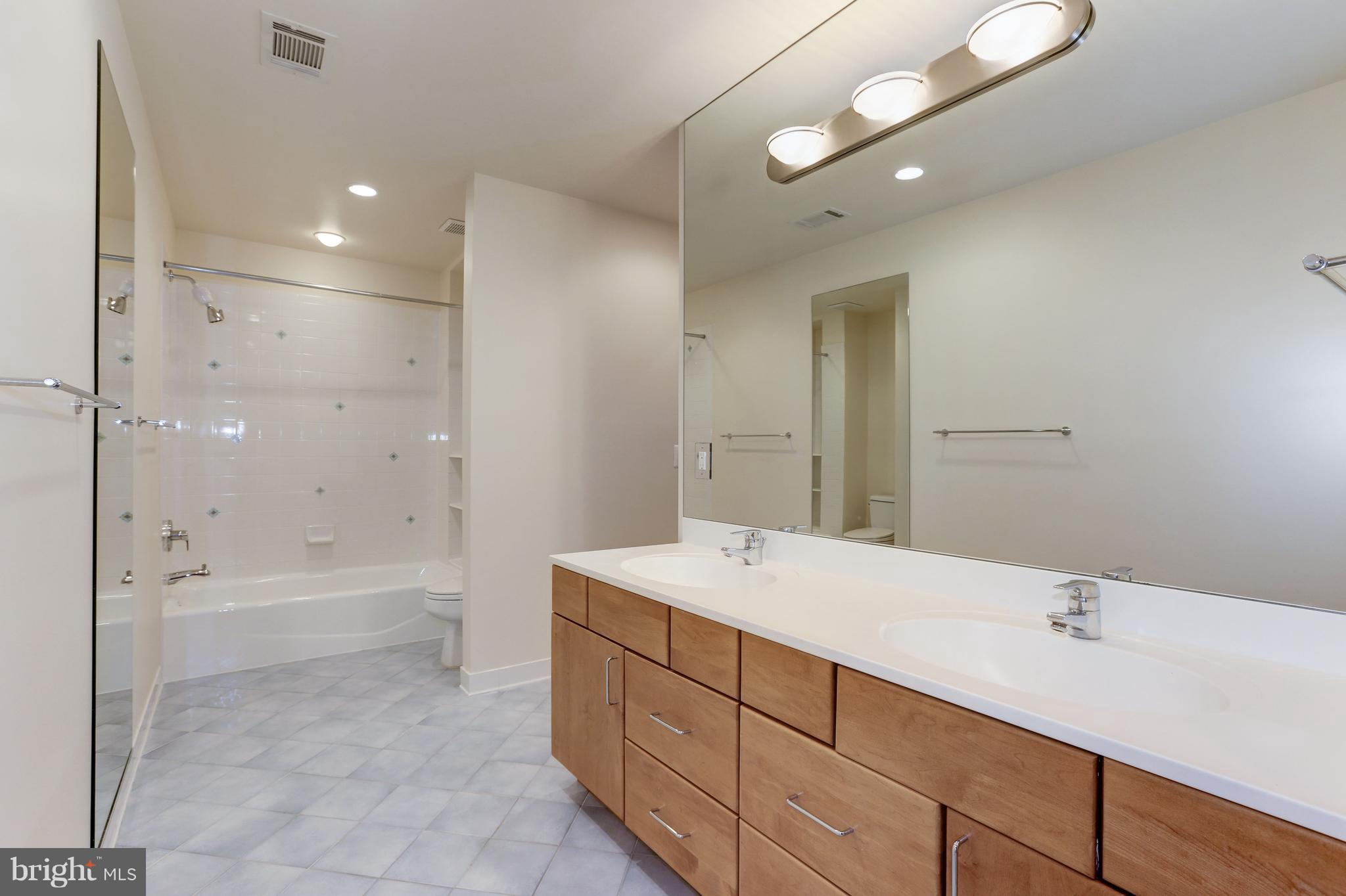 8610 Fernwood Road Bethesda, MD 20817 - Photo 23 of 30 a bathroom with a sink a toilet and shower