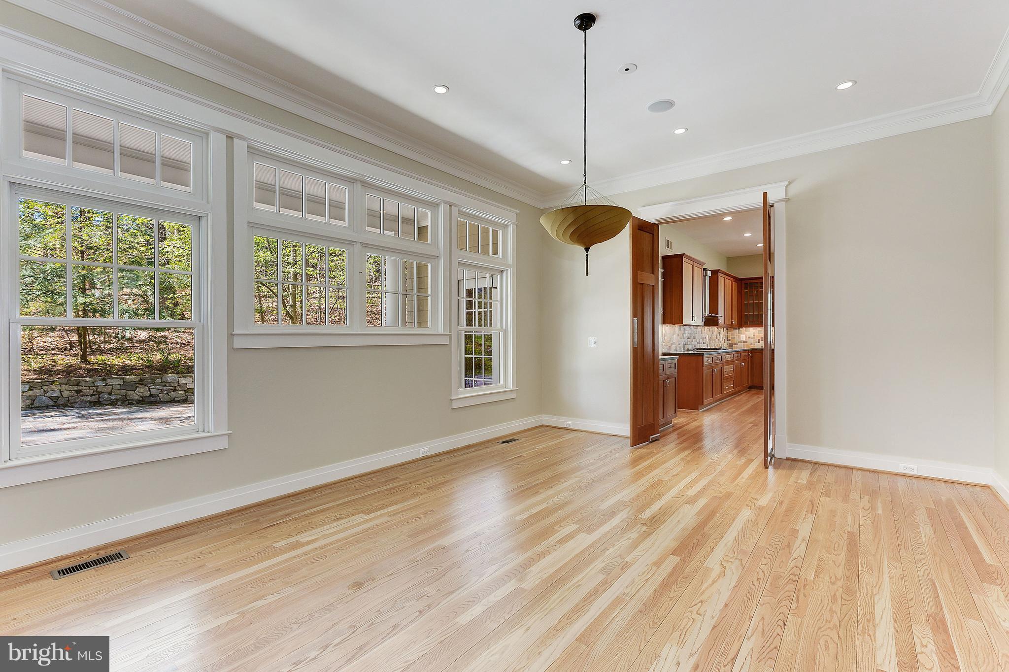 8610 Fernwood Road Bethesda, MD 20817 - Photo 6 of 30 a view of an empty room with wooden floor and a window