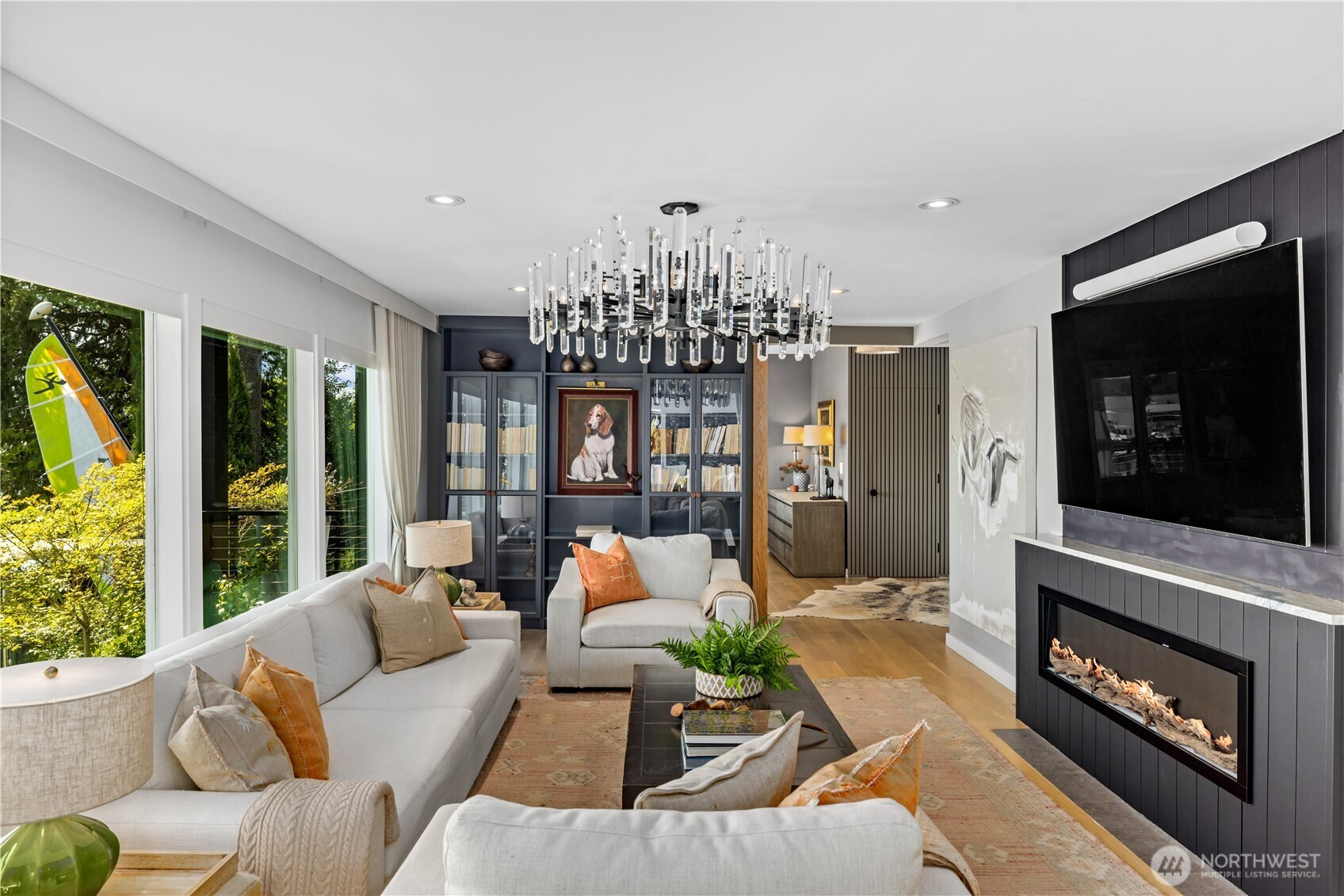 8097 West Mercer Way Mercer Island, WA 98040 - Photo 5 of 40 a living room with furniture a chandelier and a fireplace
