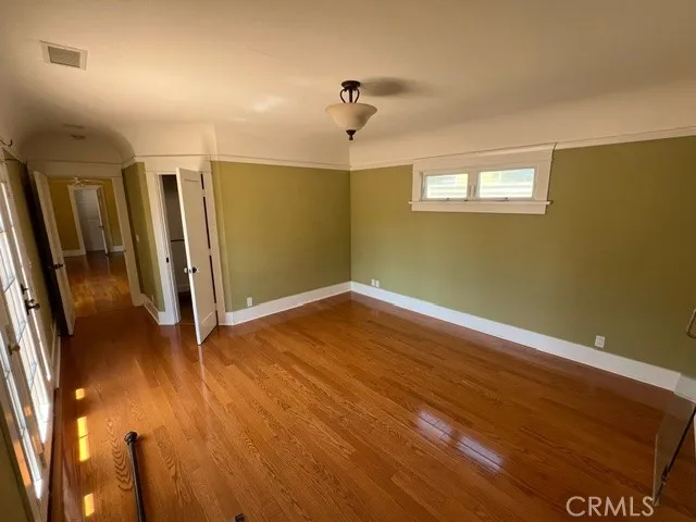 a view of a room with wooden floor and window