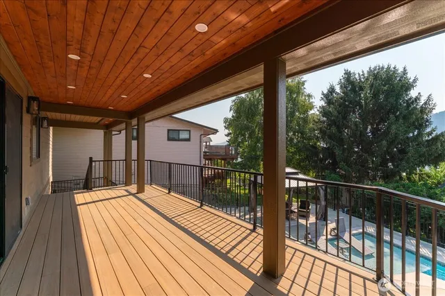 a large white bed in a large room with a large window