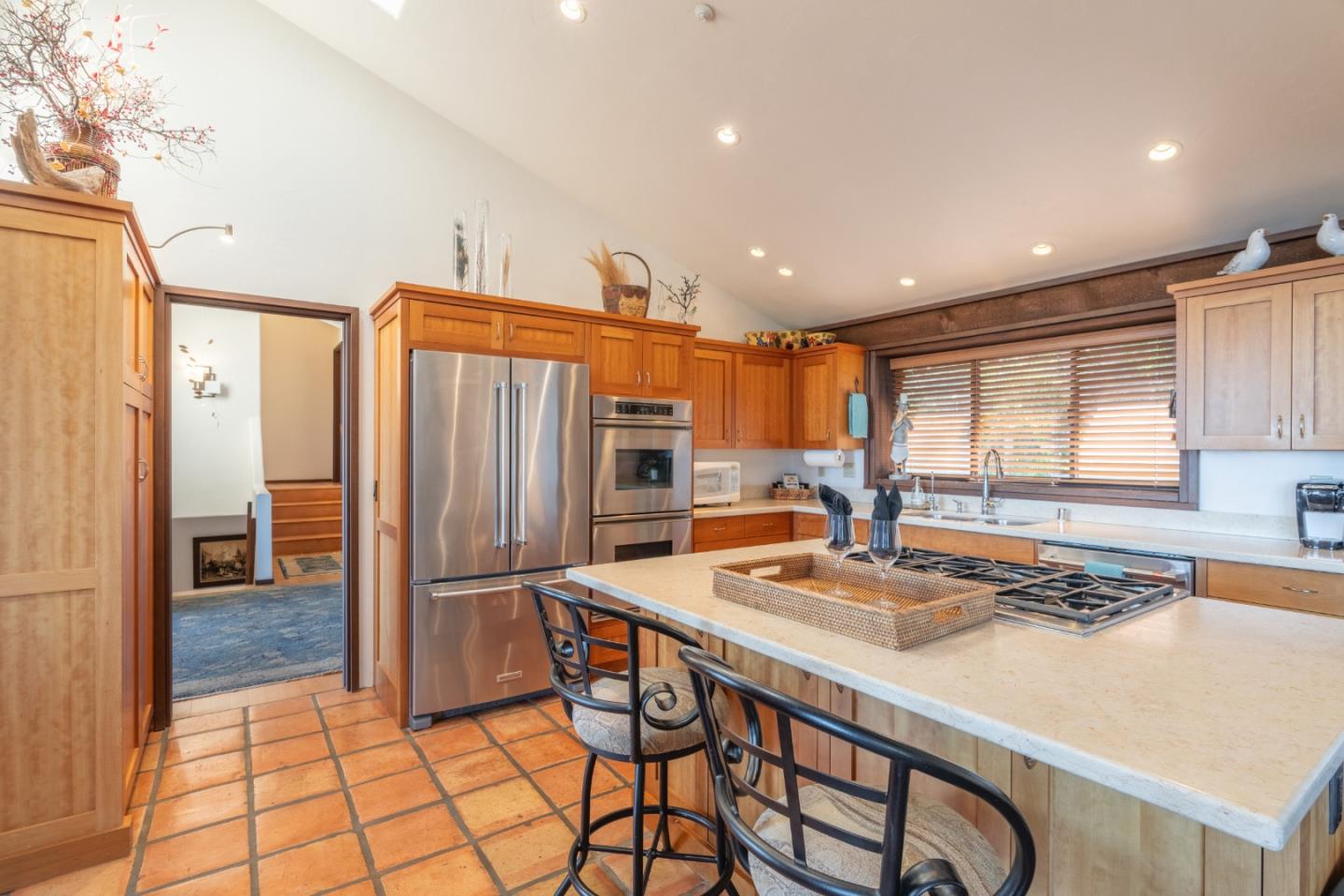 214 Crest Road Carmel, CA 93923 - Photo 9 of 29 a kitchen with stainless steel appliances granite countertop a refrigerator a stove and white cabinets with wooden floors